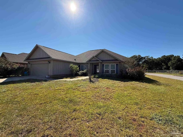 view of front of property featuring an attached garage, a front yard, and driveway