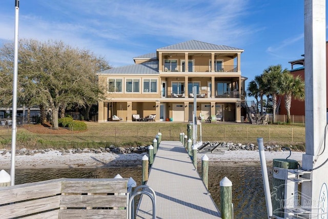 106 Matamoros Dr, Pensacola Beach, FL 32561 - rear view of property with a balcony, metal roof, fence, a water view, and a yard