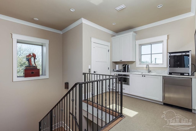 106 Matamoros Dr, Pensacola Beach, FL 32561 - kitchen with white cabinetry, visible vents, light countertops, and fridge