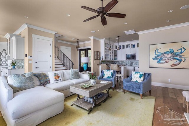 106 Matamoros Dr, Pensacola Beach, FL 32561 - living area featuring a ceiling fan, light wood-style floors, ornamental molding, and stairway