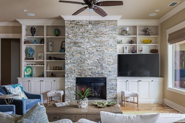 106 Matamoros Dr, Pensacola Beach, FL 32561 - living room featuring baseboards, visible vents, a ceiling fan, a stone fireplace, and built in features
