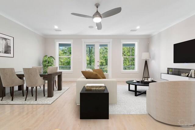 living room with plenty of natural light, ceiling fan, and light hardwood / wood-style floors