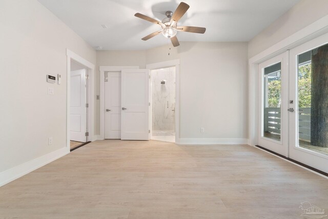 unfurnished room featuring light hardwood / wood-style flooring, french doors, and ceiling fan