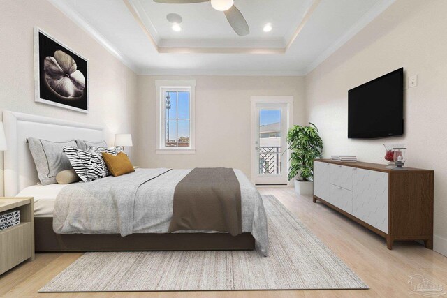 bedroom with a tray ceiling, light hardwood / wood-style flooring, and ceiling fan