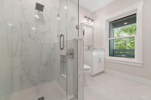 bathroom featuring tile patterned flooring, walk in shower, toilet, and vanity