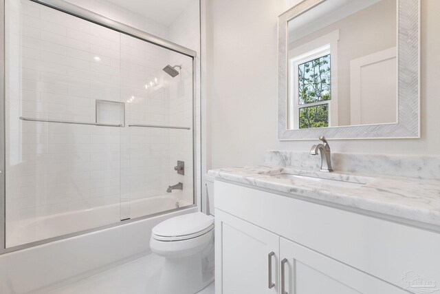 full bathroom with vanity, shower / bath combination with glass door, and toilet