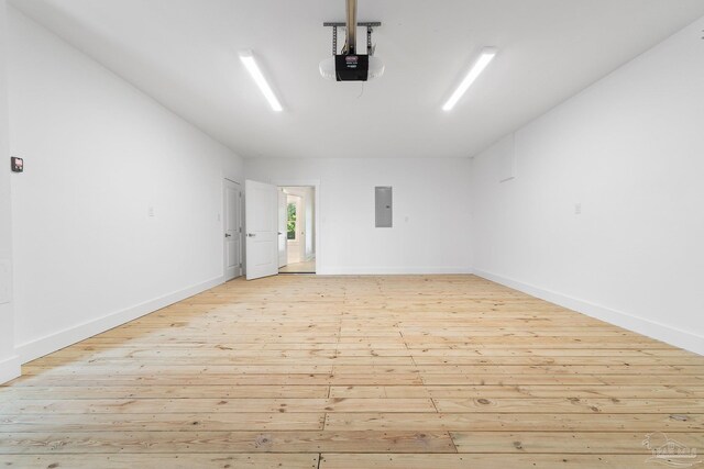 garage featuring electric panel and a garage door opener