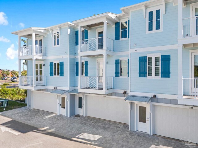 townhome / multi-family property featuring a balcony and a garage