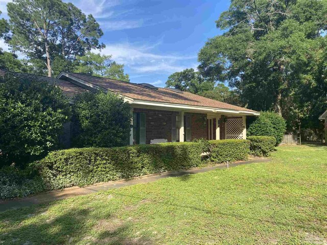 view of home's exterior with a lawn