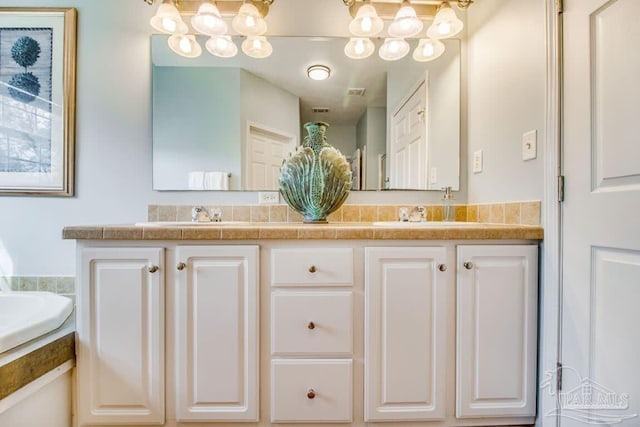 bathroom with vanity and a washtub