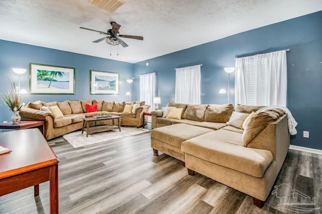 living room with hardwood / wood-style floors and ceiling fan