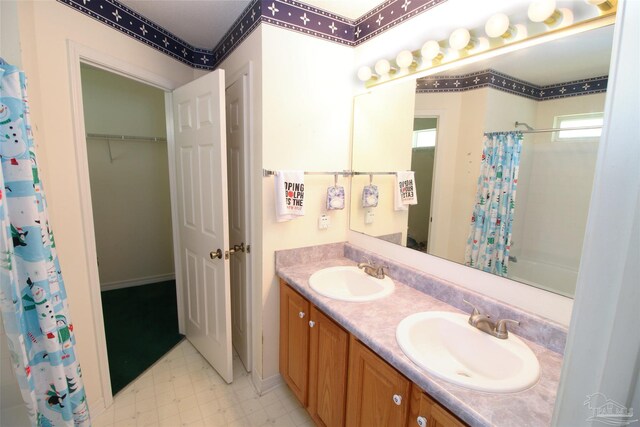 1701 Lighthouse Pointe Dr, Gulf Breeze, FL 32563 - full bath with double vanity, tile patterned floors, and shower / bath combo