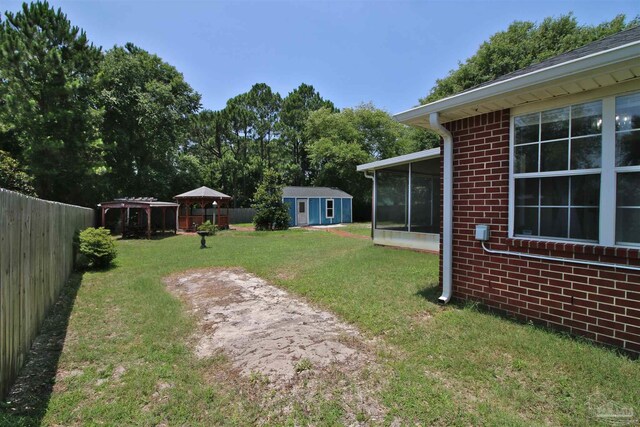 1701 Lighthouse Pointe Dr, Gulf Breeze, FL 32563 - view of yard with an outdoor structure and a sunroom