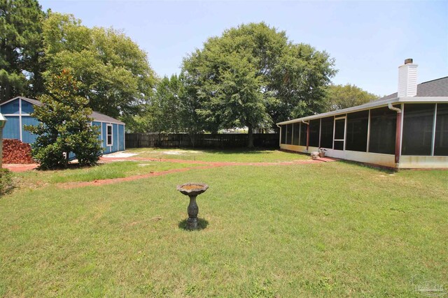 1701 Lighthouse Pointe Dr, Gulf Breeze, FL 32563 - view of yard featuring a sunroom