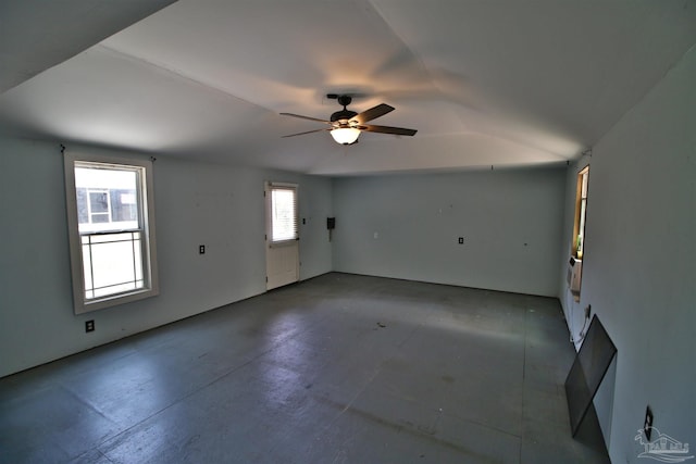 1701 Lighthouse Pointe Dr, Gulf Breeze, FL 32563 - spare room with lofted ceiling, a ceiling fan, and concrete flooring