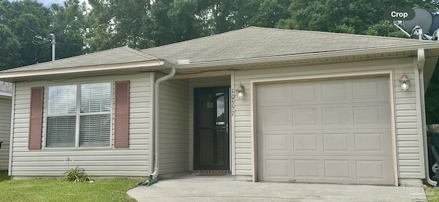 ranch-style home with a shingled roof and driveway