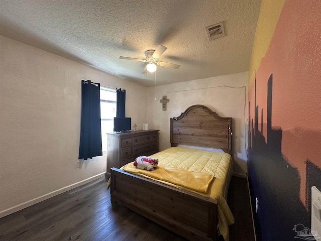 bedroom featuring dark wood finished floors, a textured ceiling, ceiling fan, and baseboards