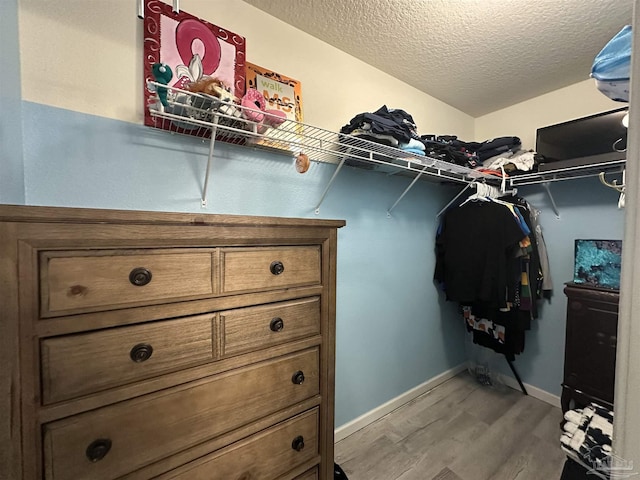 walk in closet featuring light wood-style flooring