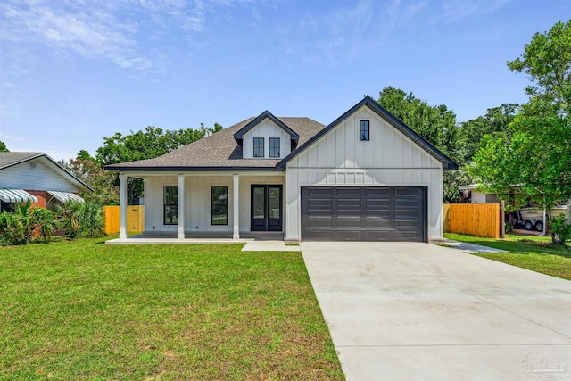 modern inspired farmhouse featuring a garage, a porch, and a front lawn