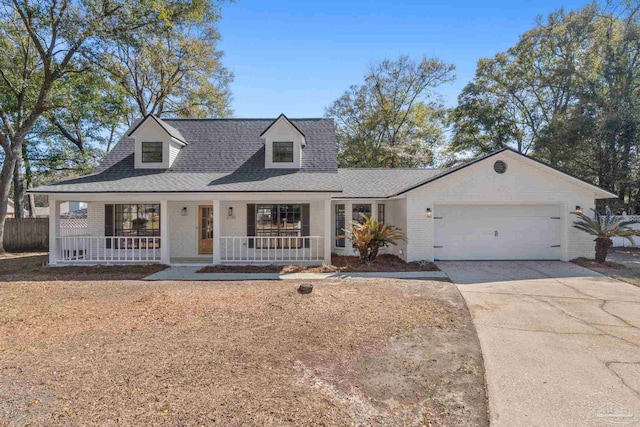 view of front facade featuring driveway, a porch, an attached garage, a shingled roof, and brick siding