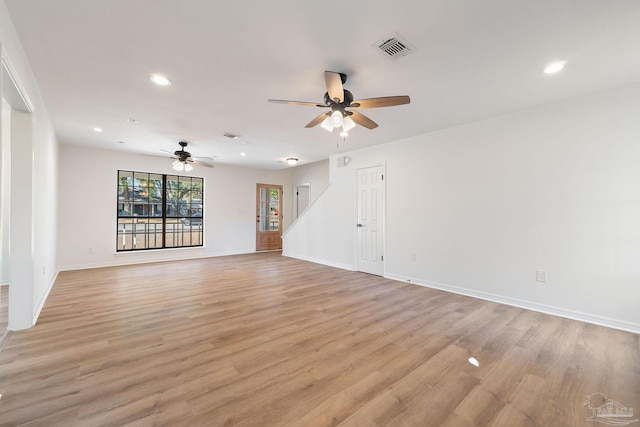 unfurnished living room featuring visible vents, recessed lighting, light wood-type flooring, and baseboards