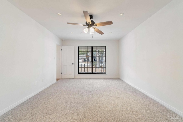 unfurnished room with carpet flooring, ceiling fan, and baseboards