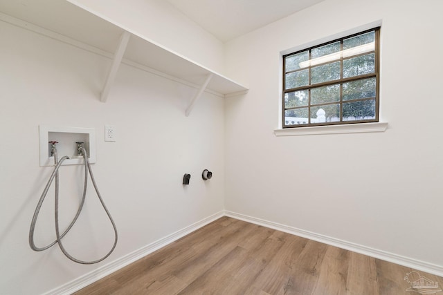 washroom featuring laundry area, hookup for a washing machine, baseboards, and light wood-type flooring