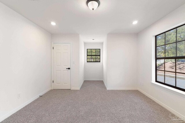 empty room with recessed lighting, baseboards, and carpet flooring