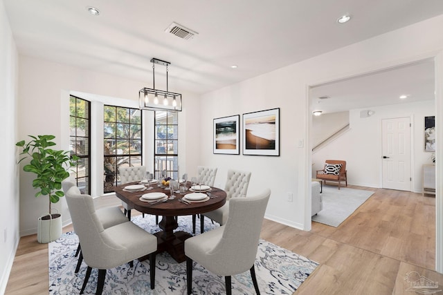 dining space with visible vents, recessed lighting, light wood-style floors, baseboards, and a chandelier