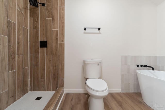 bathroom featuring tiled shower, toilet, wood finished floors, and a soaking tub