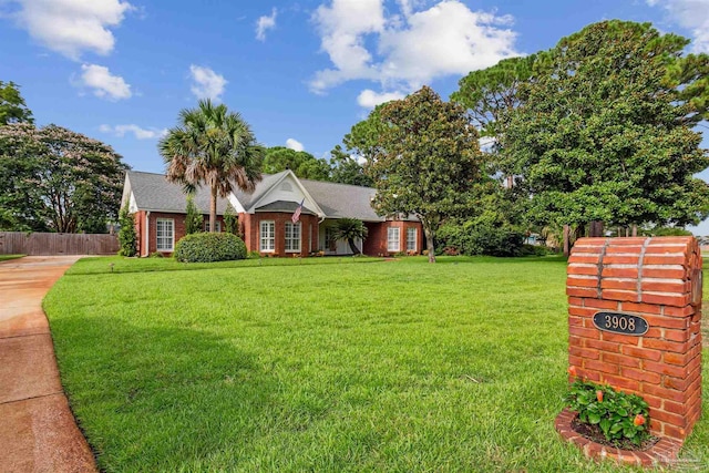 view of front of property with a front lawn and fence