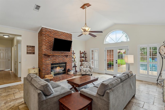 living area with french doors, stone tile floors, visible vents, a brick fireplace, and vaulted ceiling