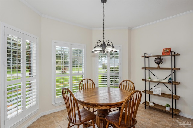 dining area featuring a healthy amount of sunlight, an inviting chandelier, baseboards, and ornamental molding