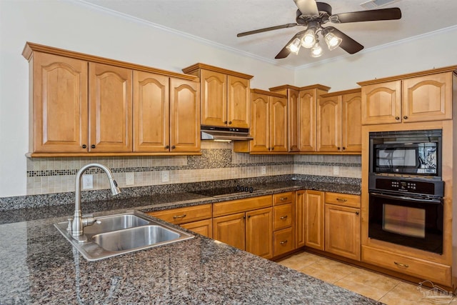 kitchen with black appliances, under cabinet range hood, backsplash, and a sink