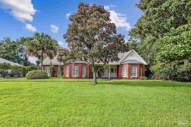 view of front of property featuring brick siding and a front yard