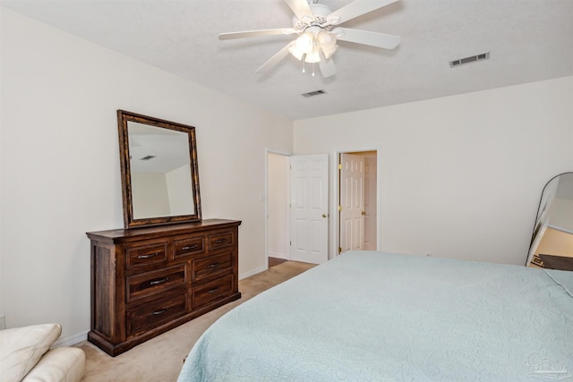 bedroom featuring light carpet, baseboards, visible vents, and a ceiling fan