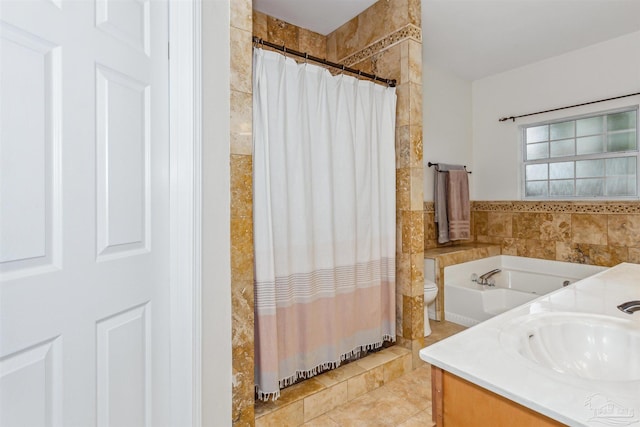 full bathroom with toilet, a sink, tile walls, a tile shower, and double vanity