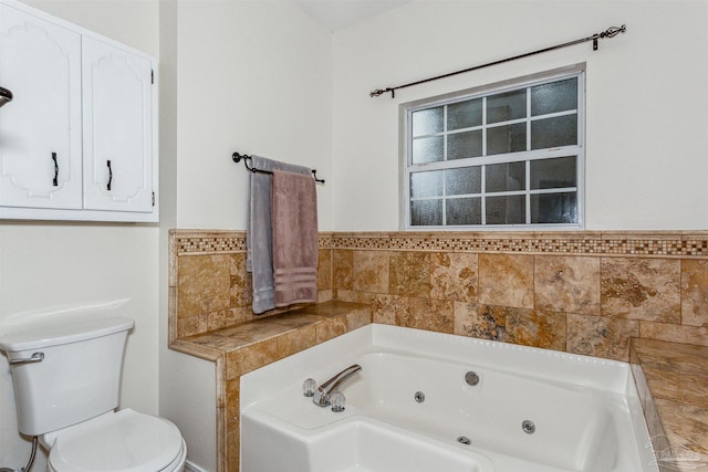 full bathroom featuring toilet and a tub with jets