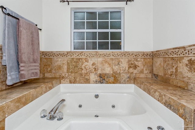 full bathroom with a whirlpool tub