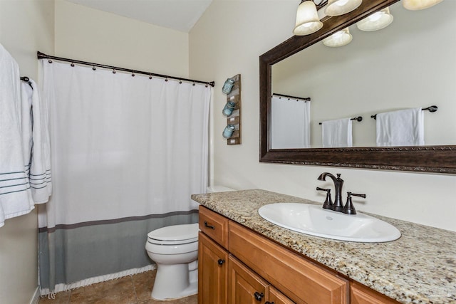 bathroom featuring tile patterned flooring, vanity, and toilet