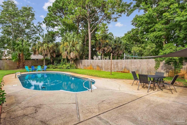 view of swimming pool featuring a patio area, a fenced backyard, a lawn, and a fenced in pool