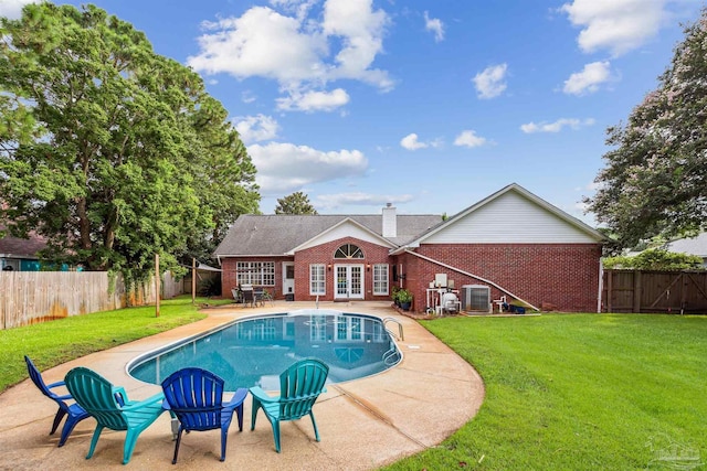 view of pool featuring a fenced in pool, french doors, a fenced backyard, a yard, and a patio area