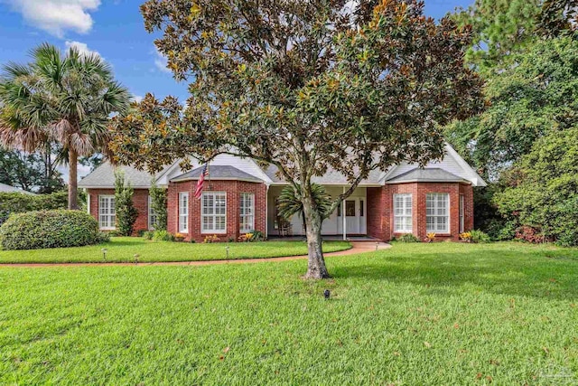 view of front of house featuring a front yard and brick siding