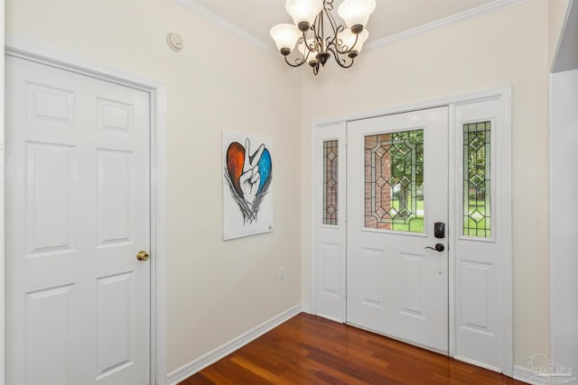 entrance foyer featuring ornamental molding, a chandelier, dark wood finished floors, and baseboards