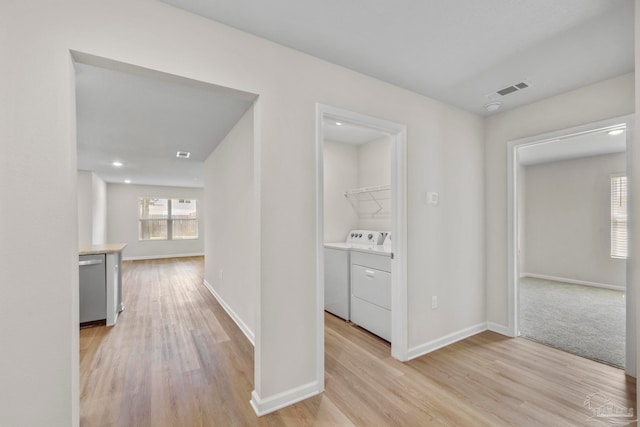 hall featuring washer and clothes dryer and light hardwood / wood-style floors