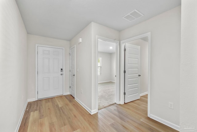 hallway with light wood-type flooring