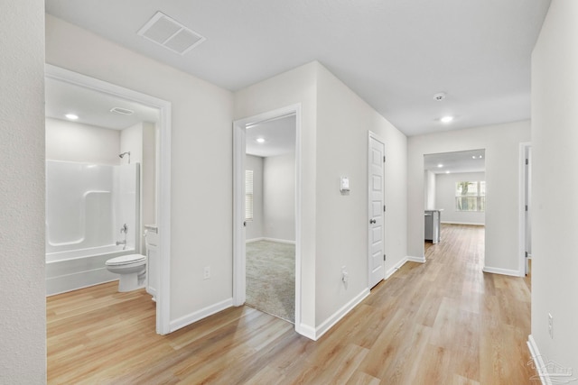 hallway with light wood-type flooring