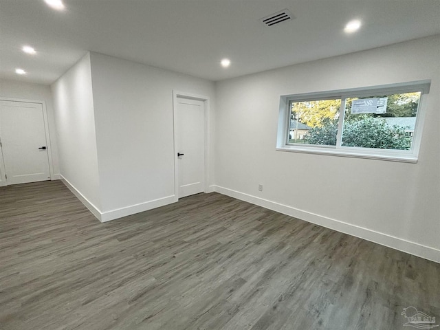 empty room with dark hardwood / wood-style flooring