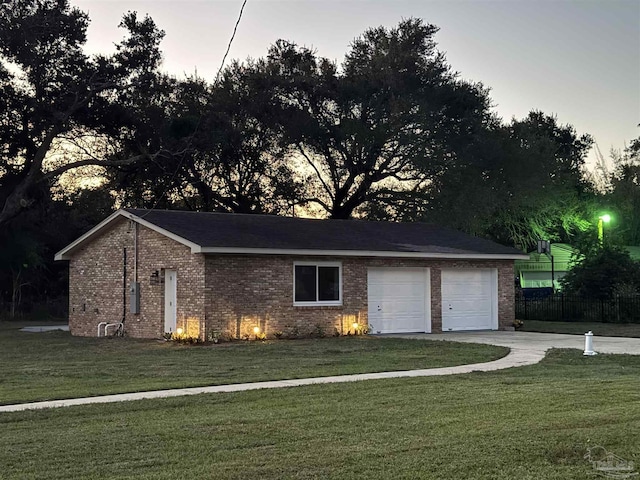 garage at dusk with a yard