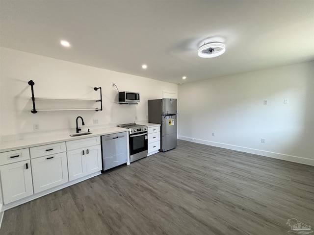 kitchen with hardwood / wood-style flooring, sink, white cabinetry, and stainless steel appliances